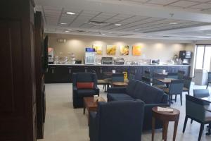 a waiting room with chairs and tables in a store at Comfort Inn & Suites Decatur-Forsyth in Forsyth