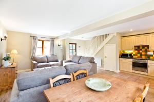 a living room with a couch and a table at Knockerdown Cottages in Ashbourne