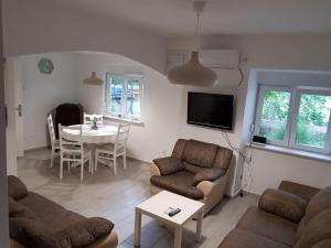 a living room with a couch and a table at Apartment Nona in Šmrika