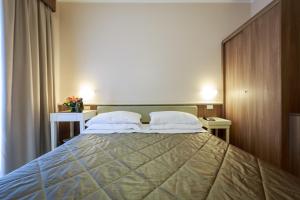 a bedroom with a large bed with two pillows at Hotel Mirasole International in Gaeta