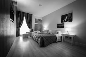 a bedroom with a bed and a desk and a window at Hotel Mirasole International in Gaeta