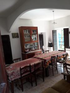 a dining room with a table and some chairs at Azzone Cascina nel verde in Azzone