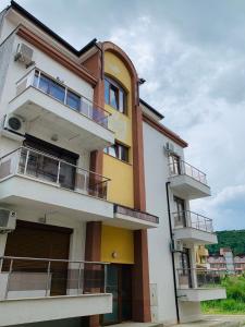 a building with balconies on the side of it at Obzor Tatyana Apartaments Bonjour in Obzor