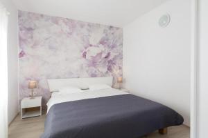 una camera con letto e parete floreale di Apartment Tomislav a Vir (Puntadura)