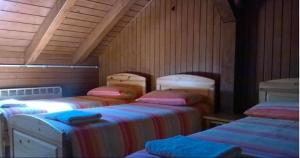 a room with three beds in a attic at Rifugio 2000 in Alpe Ciamporino