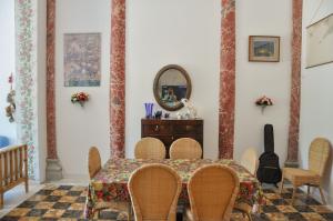 comedor con mesa, sillas y espejo en Luxury apartment inside beachfront villa, en Donoratico