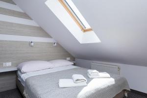 Postel nebo postele na pokoji v ubytování Willa Arielka