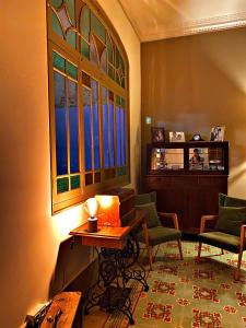 a living room with a table and chairs and a window at Can Martí in Vallgorguina
