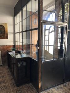 a room with a desk and a glass door at Can Martí in Vallgorguina