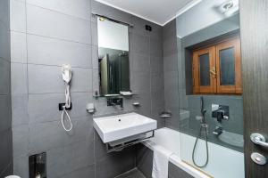 a bathroom with a sink and a shower at Imperium Suite Navona in Rome
