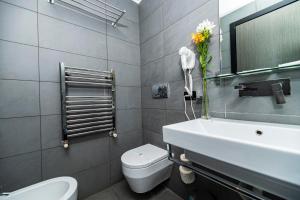 ein Badezimmer mit einem Waschbecken, einem WC und einem Spiegel in der Unterkunft Imperium Suite Navona in Rom