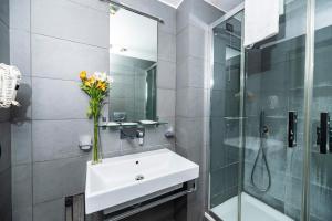 a bathroom with a sink and a glass shower at Imperium Suite Navona in Rome