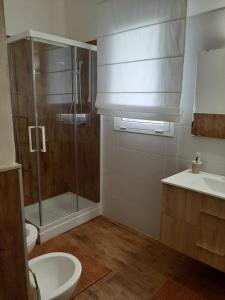 a bathroom with a shower and a toilet and a sink at Villetta Siciliana "Dal PICCIOTTO" in Marsala