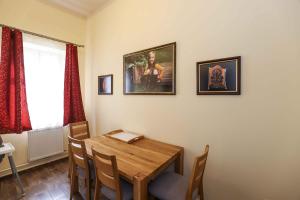 a dining room with a wooden table and chairs at Apartmán Schindlerka in Banská Štiavnica +3 photos