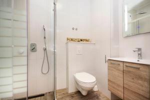 a bathroom with a shower and a toilet and a sink at Apartments Makarska in Makarska