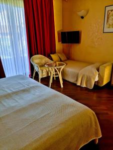 Postel nebo postele na pokoji v ubytování Serravalle Golf Hotel