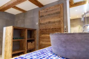 a kitchen with a wooden door and a table at Ferienwohnung Birkentalblick in Nesselwängle