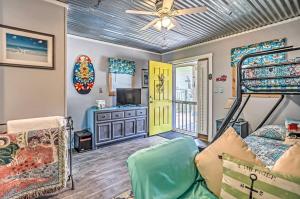a bedroom with a bunk bed and a couch at Ocean Isle Beach Studio 1 Mi to Downtown and Pier in Ocean Isle Beach