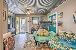 a living room with a bed and a table at Ocean Isle Beach Studio 1 Mi to Downtown and Pier in Ocean Isle Beach