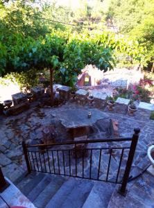 a garden with a stone patio with a fountain at Kria springs in Livadeia