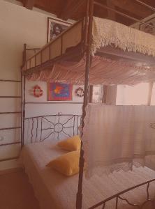 a bedroom with a canopy bunk bed with white sheets at Kria springs in Livadeia
