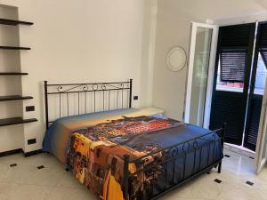 1 dormitorio con 1 cama con edredón en Appartamento Maraschino, en Levanto