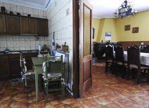 a kitchen with a table and chairs and a door at El Capricho del Tejar in Cimanes del Tejar +42 photos