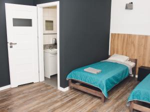 Łóżko lub łóżka w pokoju w obiekcie Noclegi CS17