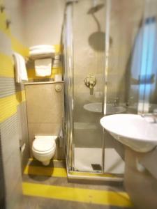 a bathroom with a shower and a toilet and a sink at Hotel Della Baia in Portovenere