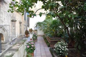 a walkway with flowers and plants on a building at Giardino d'Atri in Naples