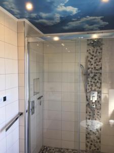 a bathroom with a shower with a painting of a sky on the ceiling at Feriendomizil im Musikerviertel in Otterndorf in Otterndorf +53 photos