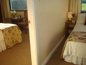 A bed or beds in a room at Athlumney Manor Guest Accommodation