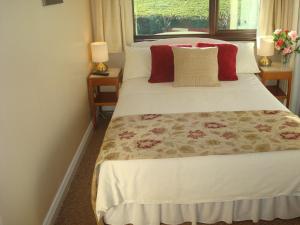 A bed or beds in a room at Athlumney Manor Guest Accommodation
