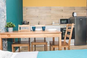 a kitchen with a table with chairs and a refrigerator at Apartamenty w Świeciu CS17 in Świecie +12 photos