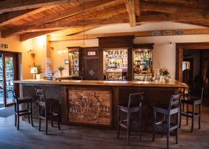 a bar in a restaurant with chairs around it at Hotel Ranczo Smyczyna in Smyczyna