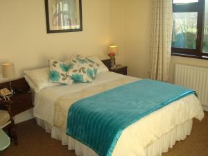 A bed or beds in a room at Athlumney Manor Guest Accommodation