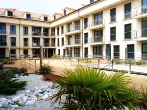 a large building with a courtyard in front of it at Fisterracons in Finisterre