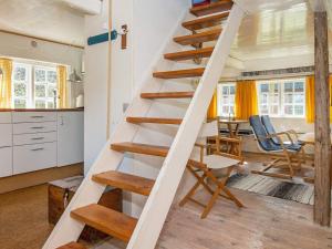 een trap in een keuken met een tafel en stoelen bij 4 person holiday home in Fan in Fanø