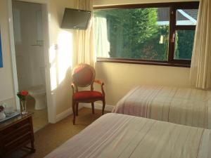 A bed or beds in a room at Athlumney Manor Guest Accommodation