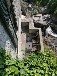 an outdoor stairway with a bench and some plants at La Ruota del Mulino in Nesso