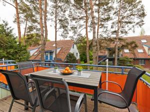 a black table and chairs on a balcony at Spacious Apartment in Boltenhagen by the Sea in Boltenhagen