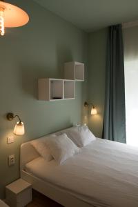 a bedroom with a bed with two lights on it at SMILE&LOVE REPUBLIC ZAGREB CENTER in Zagreb