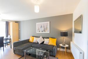 a living room with a couch and a table at Velvet 1-bedroom apartment, Clockhouse, Hoddesdon in Hoddesdon