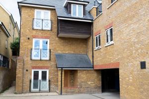 a brick building with a black roof at Velvet 1-bedroom apartment, Clockhouse, Hoddesdon in Hoddesdon