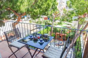 a blue table and chairs on a balcony at Montroig Zen Penthouse by Hello Homes Sitges in Sitges