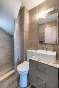 Un baño con un inodoro blanco y un lavabo. en Big Blue suites 1, en Ierápetra