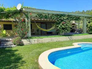 a house with a swimming pool in a yard at La Caseta de Mollet in Benifallet