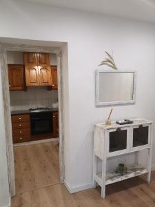 a kitchen with wooden cabinets and a table with a mirror at Casa Serral in Deltebre +16 photos