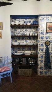 a room with blue and white dishes and a wall at La Casita del Tejo in Hervás