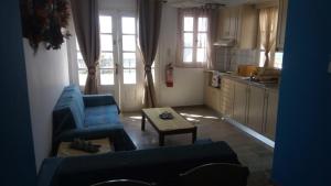 a living room with a couch and a table at John Galouzis Studios in Kalymnos